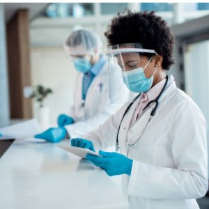 african-american-doctor-working-on-touchpad-at-reception-desk-in-the-picture-id1288964081 (1)